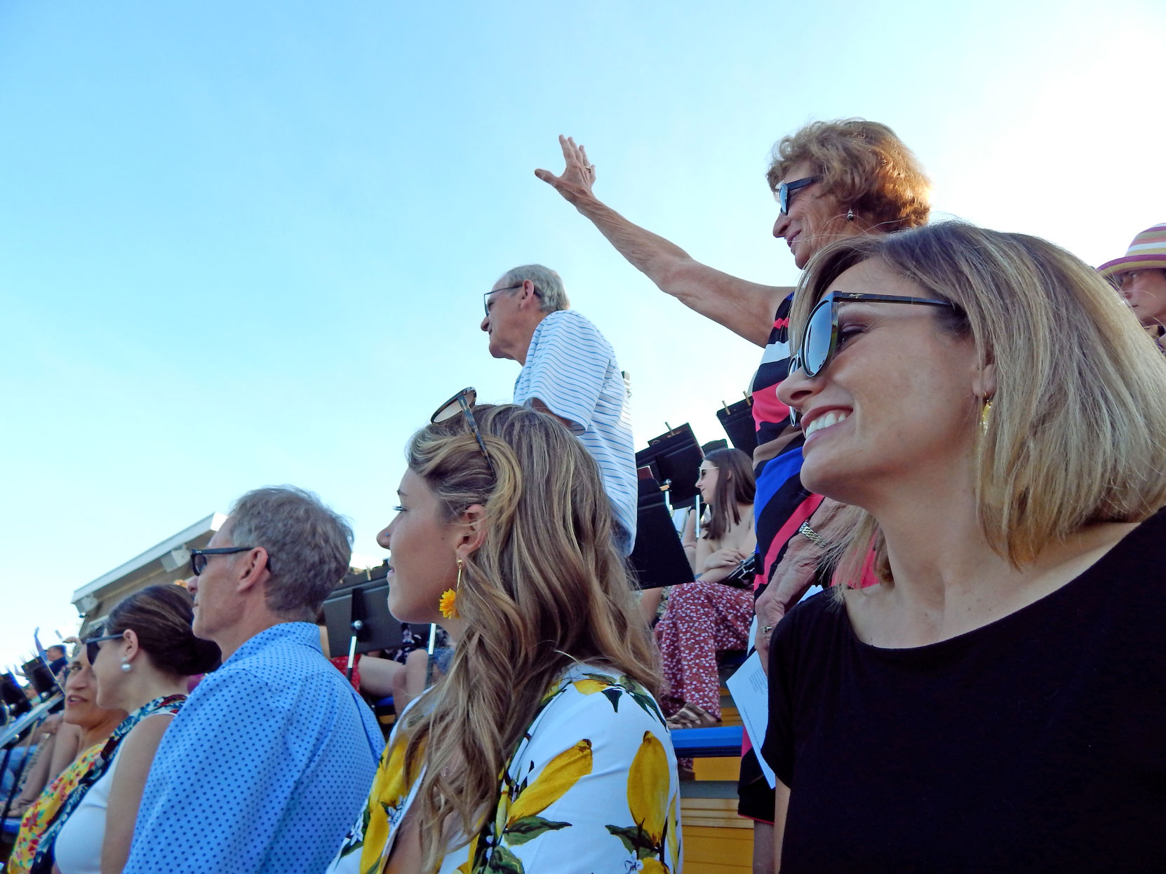 Norma Michaud, grandmother of graduate Jocelyn Rice, stands and waves at the request of Principal Jon Koeng, who asked all grandparents to stand up so they could be recognized and thanked by the students.
